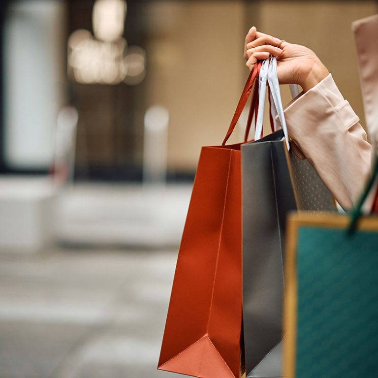 Close up of woman spending a dat in shopping. Copy space.